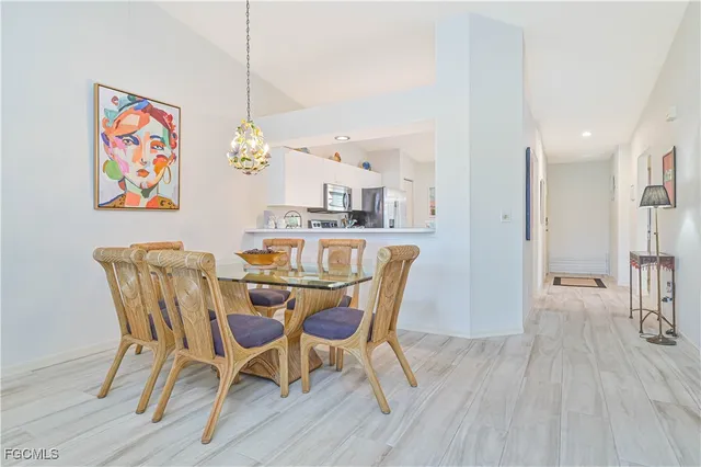 a view of a dining room with furniture wooden floor and a chandelier