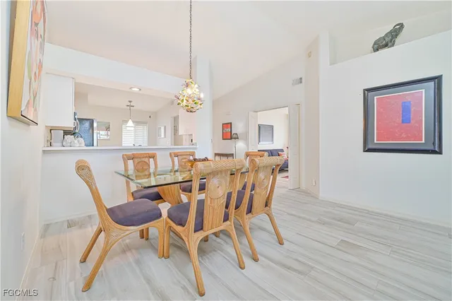 a view of a dining room with furniture and a chandelier