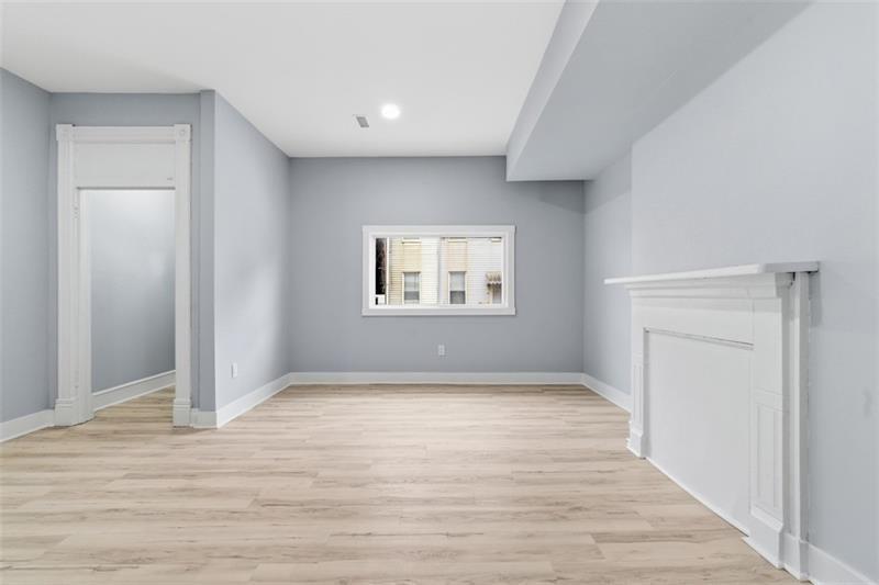 1150 Goettmann Street Pittsburgh, PA 15212 - Photo 12 of 36 a view of an empty room with wooden floor and a window