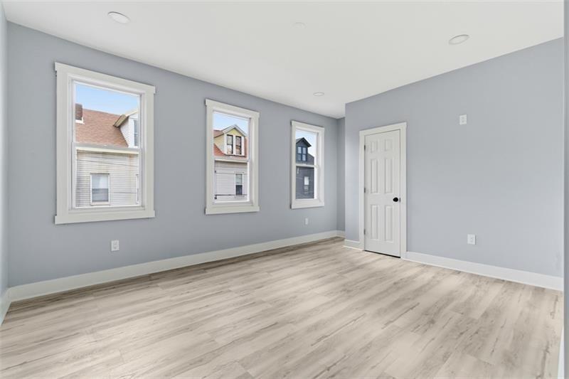 1150 Goettmann Street Pittsburgh, PA 15212 - Photo 26 of 36 a view of an empty room with wooden floor and a window