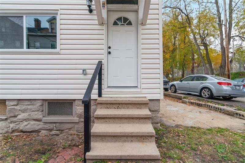 1150 Goettmann Street Pittsburgh, PA 15212 - Photo 34 of 36 a view of a house with a yard and large tree