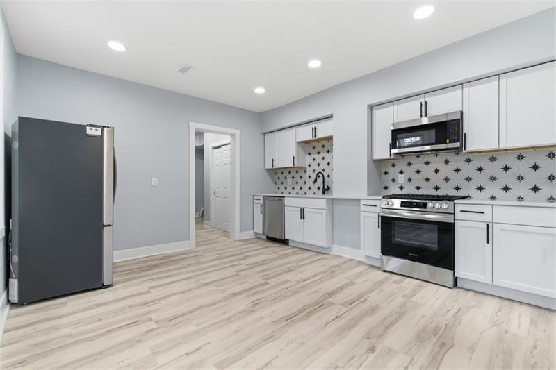 1150 Goettmann Street Pittsburgh, PA 15212 - Photo 4 of 36 a kitchen with stainless steel appliances kitchen island granite countertop a stove and a refrigerator