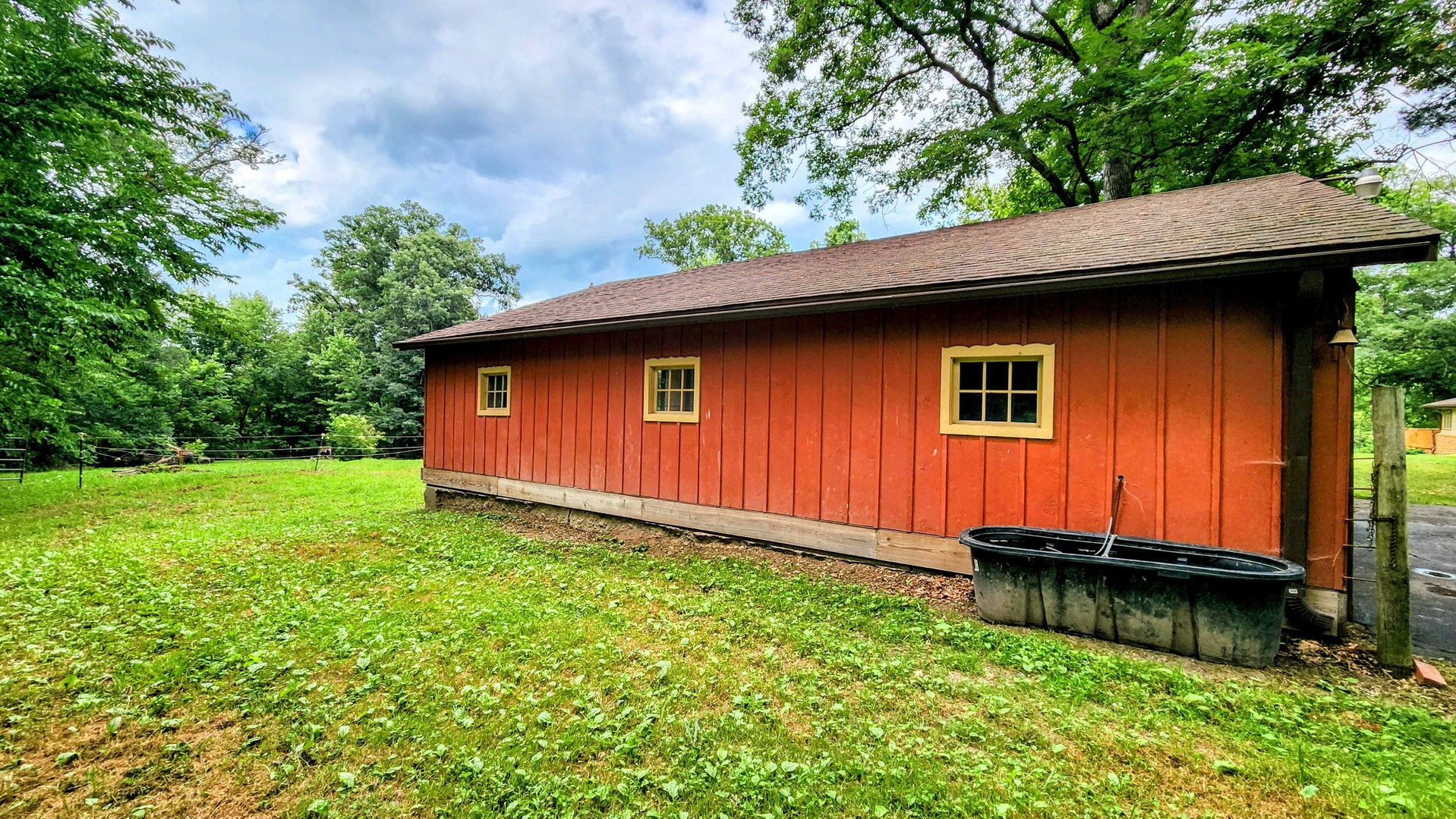 20798 White Oaks Road Morrison, IL 61270 - Photo 12 of 48 a backyard of a house with yard plants and large tree