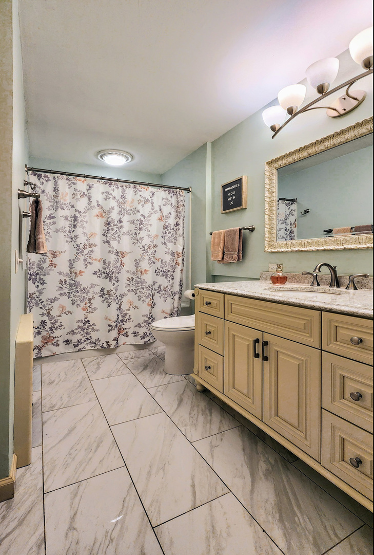 20798 White Oaks Road Morrison, IL 61270 - Photo 20 of 48 a spacious bathroom with a granite countertop sink a mirror and a bathtub