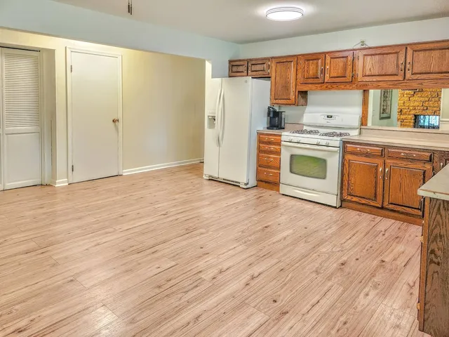 a kitchen with a stove a sink and a refrigerator