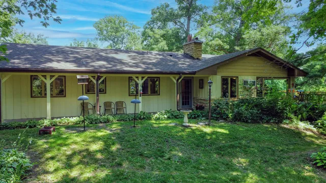 an aerial view of green landscape with trees houses and mountain view