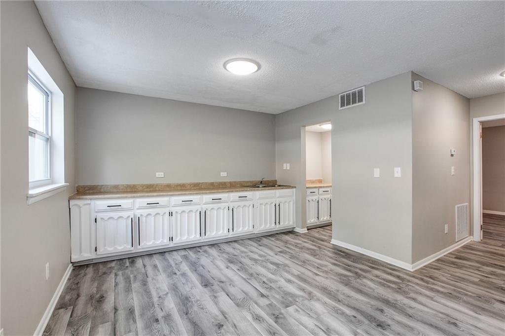 7325 Cardigan Circle Atlanta, GA 30328 - Photo 1 of 25 a view of an empty room with wooden floor and a window