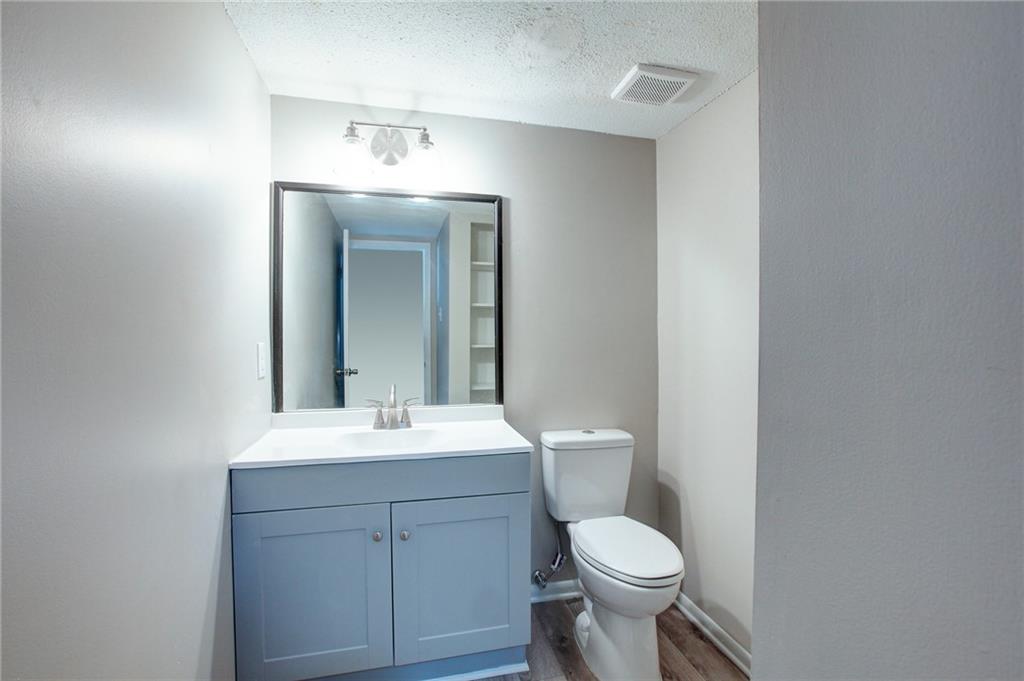 7325 Cardigan Circle Atlanta, GA 30328 - Photo 12 of 25 a bathroom with a toilet sink and mirror