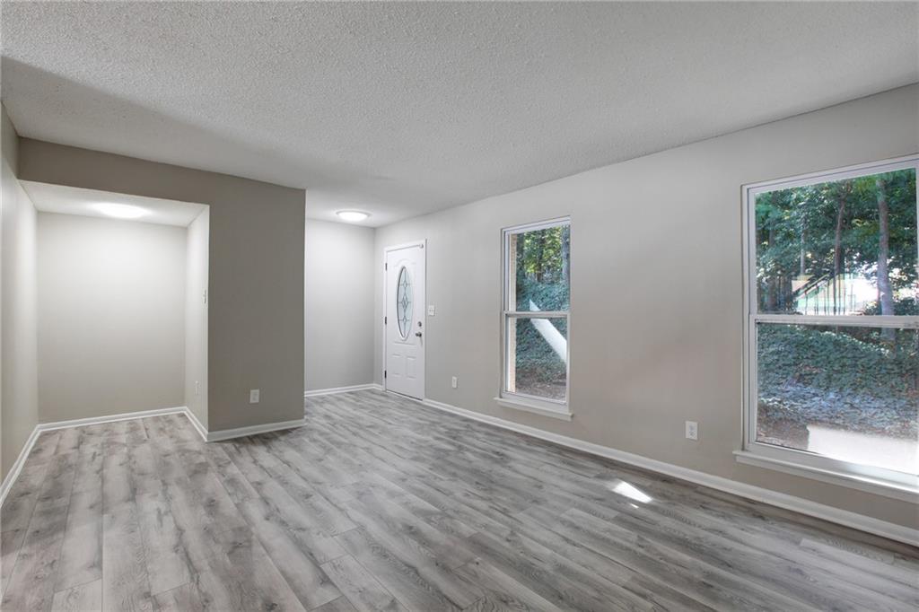 7325 Cardigan Circle Atlanta, GA 30328 - Photo 13 of 25 a view of an empty room with wooden floor and a window