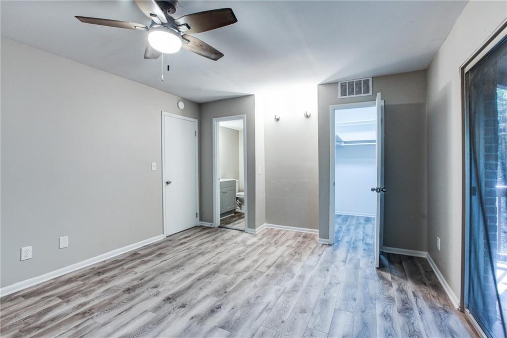 7325 Cardigan Circle Atlanta, GA 30328 - Photo 19 of 25 wooden floor in an empty room with a window