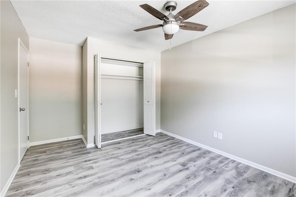 7325 Cardigan Circle Atlanta, GA 30328 - Photo 24 of 25 an empty room with wooden floor and a ceiling fan