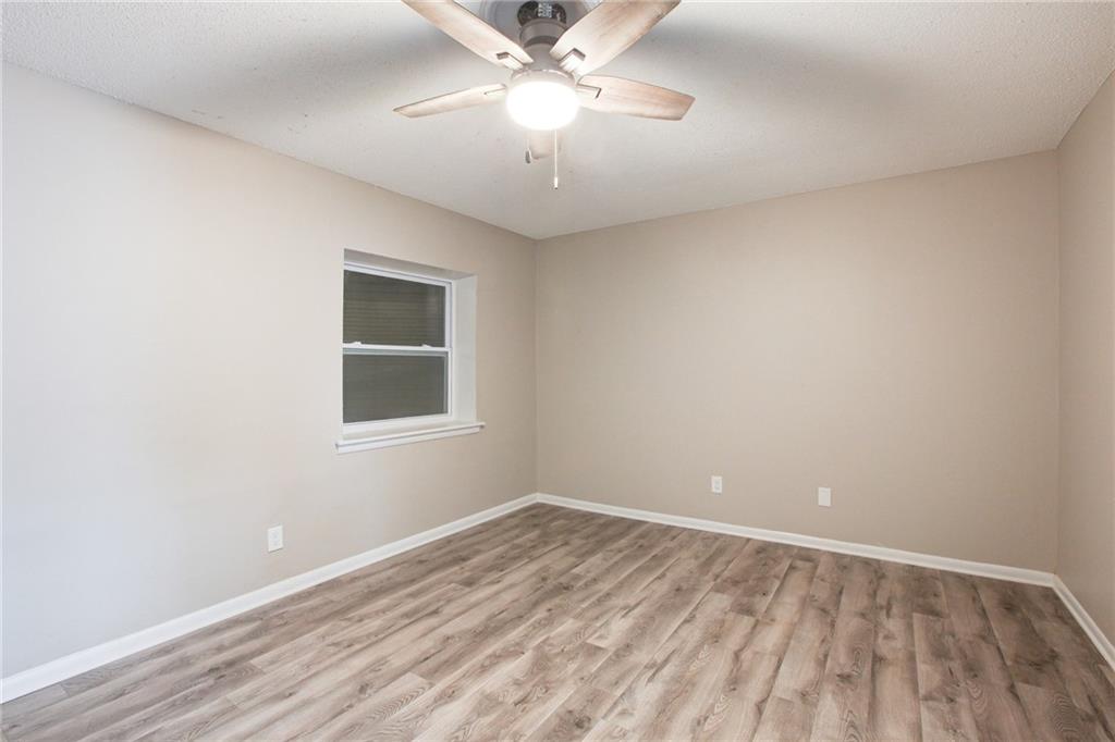 7325 Cardigan Circle Atlanta, GA 30328 - Photo 5 of 25 a view of an empty room with window and chandelier fan