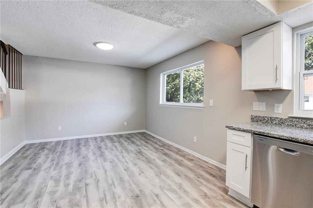 7325 Cardigan Circle Atlanta, GA 30328 - Photo 10 of 25 a view of kitchen with granite countertop cabinets and window