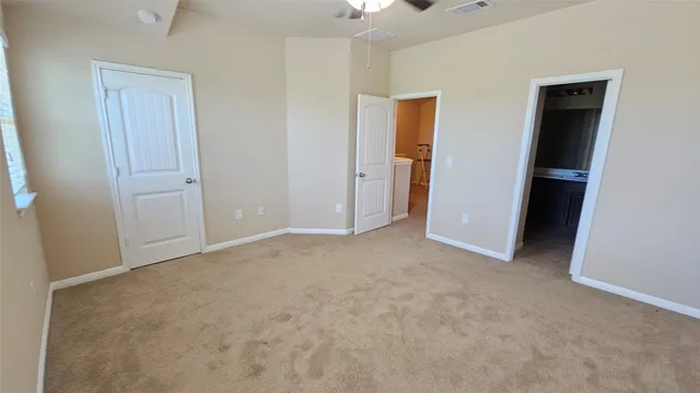 a view of an empty room and closet area
