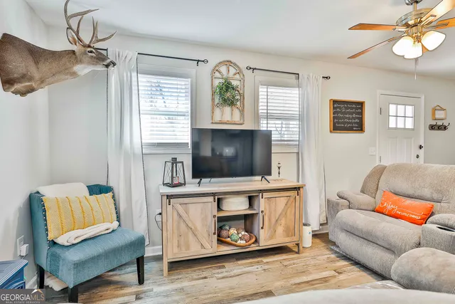 a living room with furniture and a flat screen tv