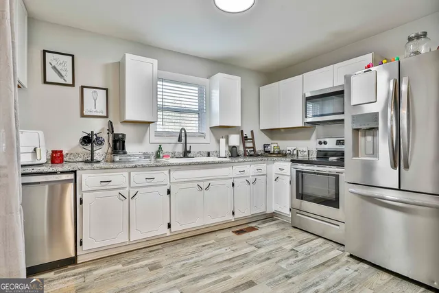 a kitchen with a refrigerator stove and sink