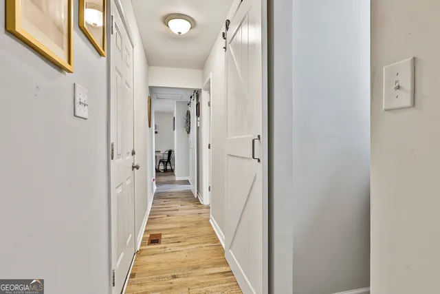 a view of a hallway with a wooden door