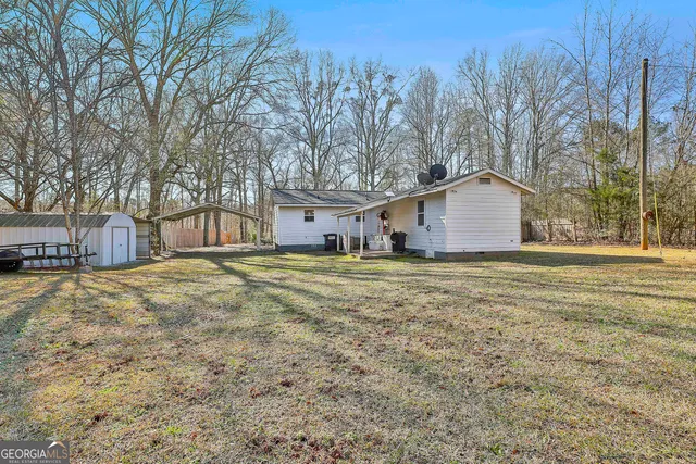 a backyard of apartments with large trees