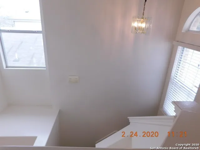 a view of a hallway with windows