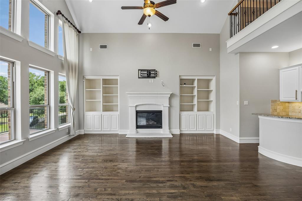 134 Santa Rosa Way Irving, TX 75062 - Photo 2 of 26 Spacious living room with dramatic ceilings, wood floors, and seamless sightlines to the outdoor living space.