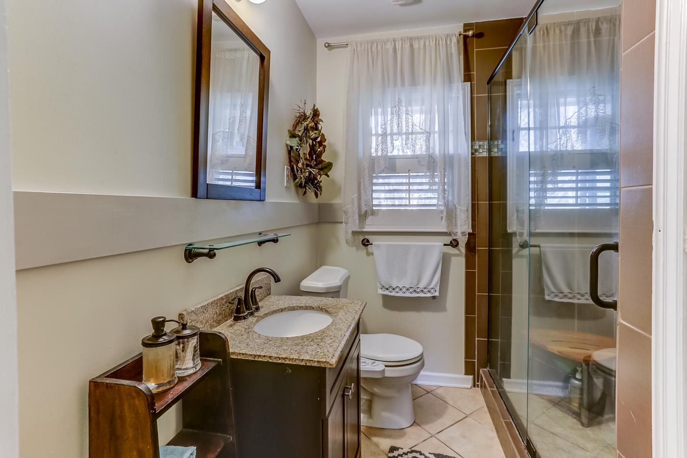 5126 Walnut Grove Road Memphis, TN 38117 - Photo 14 of 23 a bathroom with a sink toilet a mirror and shower