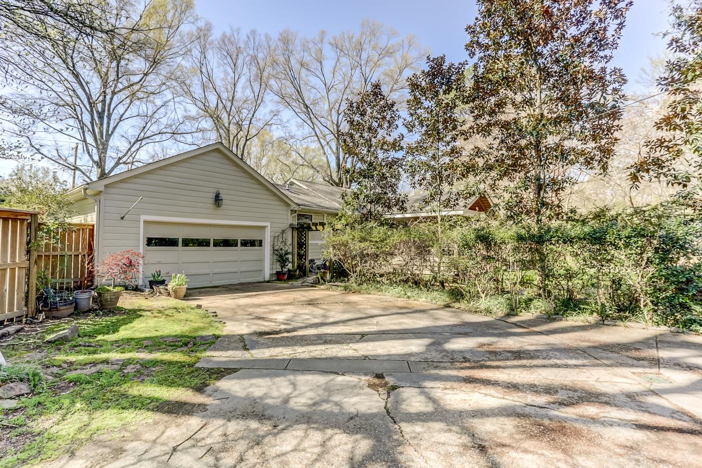 5126 Walnut Grove Road Memphis, TN 38117 - Photo 22 of 23 a front view of a house with a yard and trees