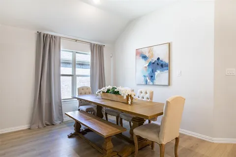 a view of a workspace with furniture and wooden floor