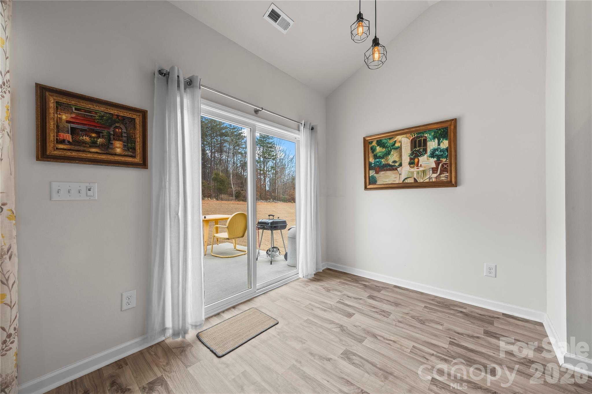7380 Latham Way Denver, NC 28037 - Photo 13 of 39 an empty room with wooden floor and windows