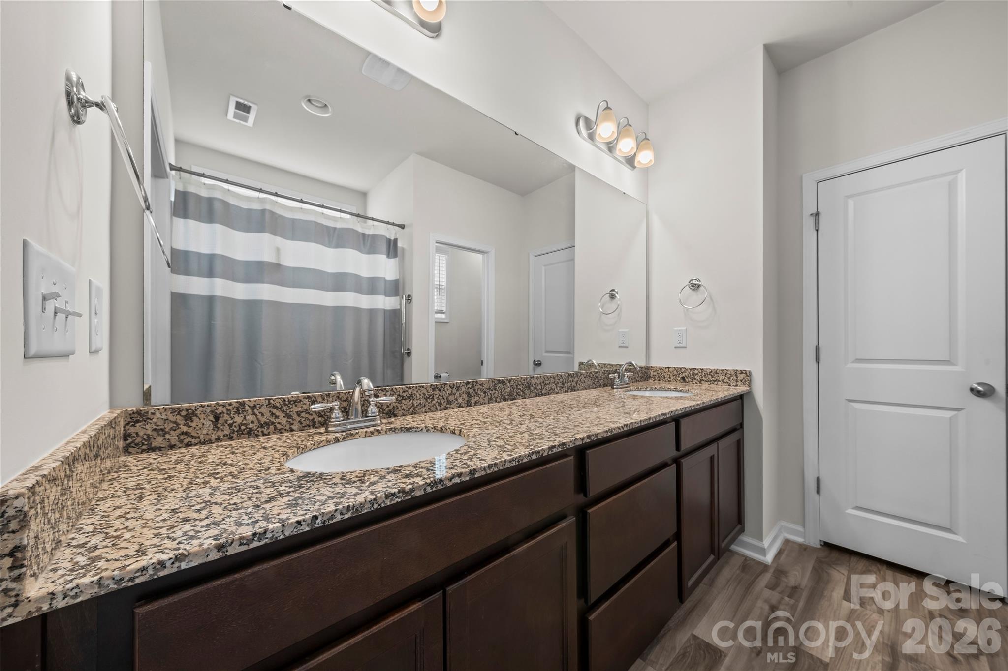7380 Latham Way Denver, NC 28037 - Photo 19 of 39 a bathroom with a granite countertop double vanity sink and a mirror