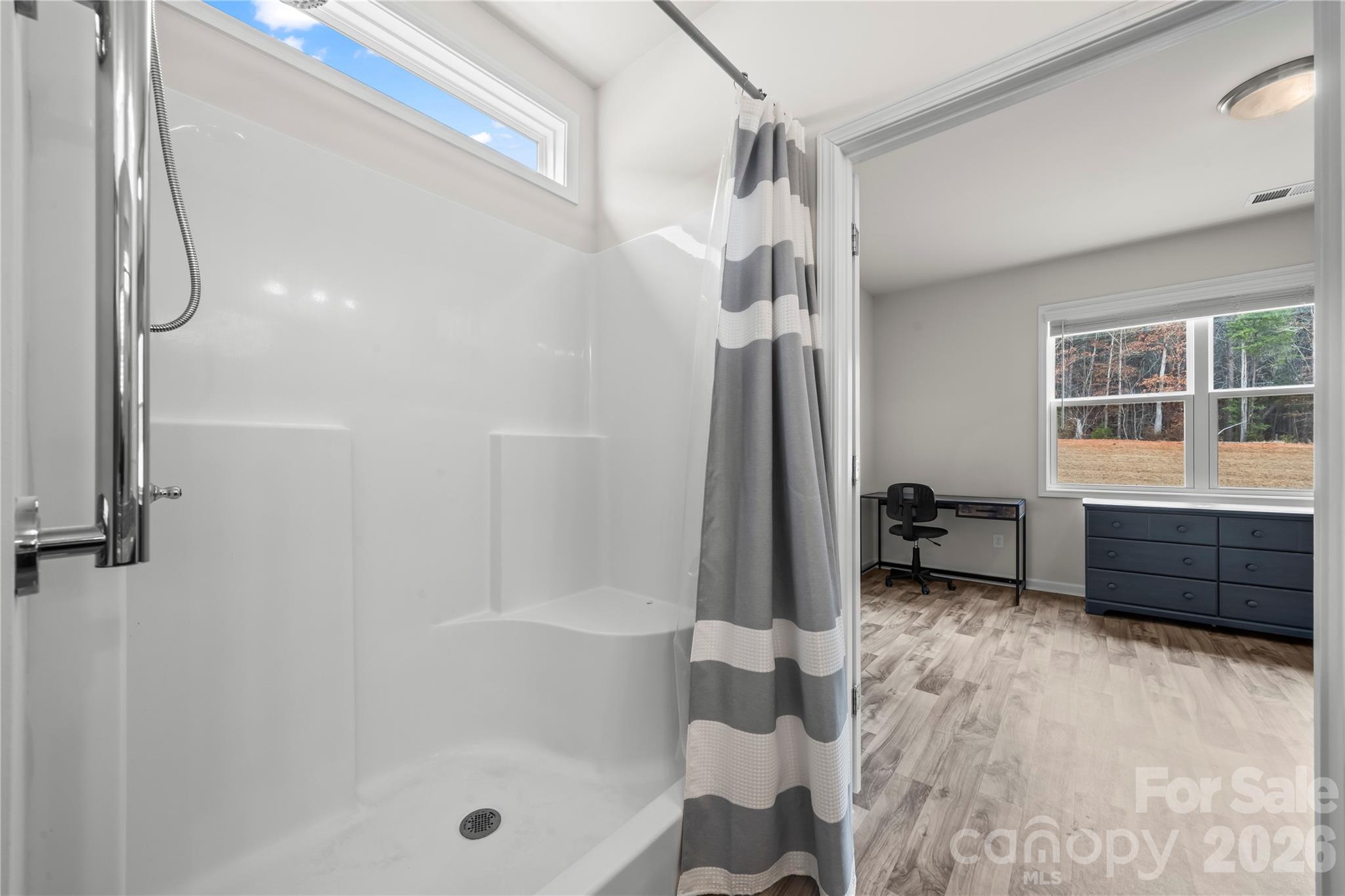 7380 Latham Way Denver, NC 28037 - Photo 20 of 39 a bathroom with a tub and a shower