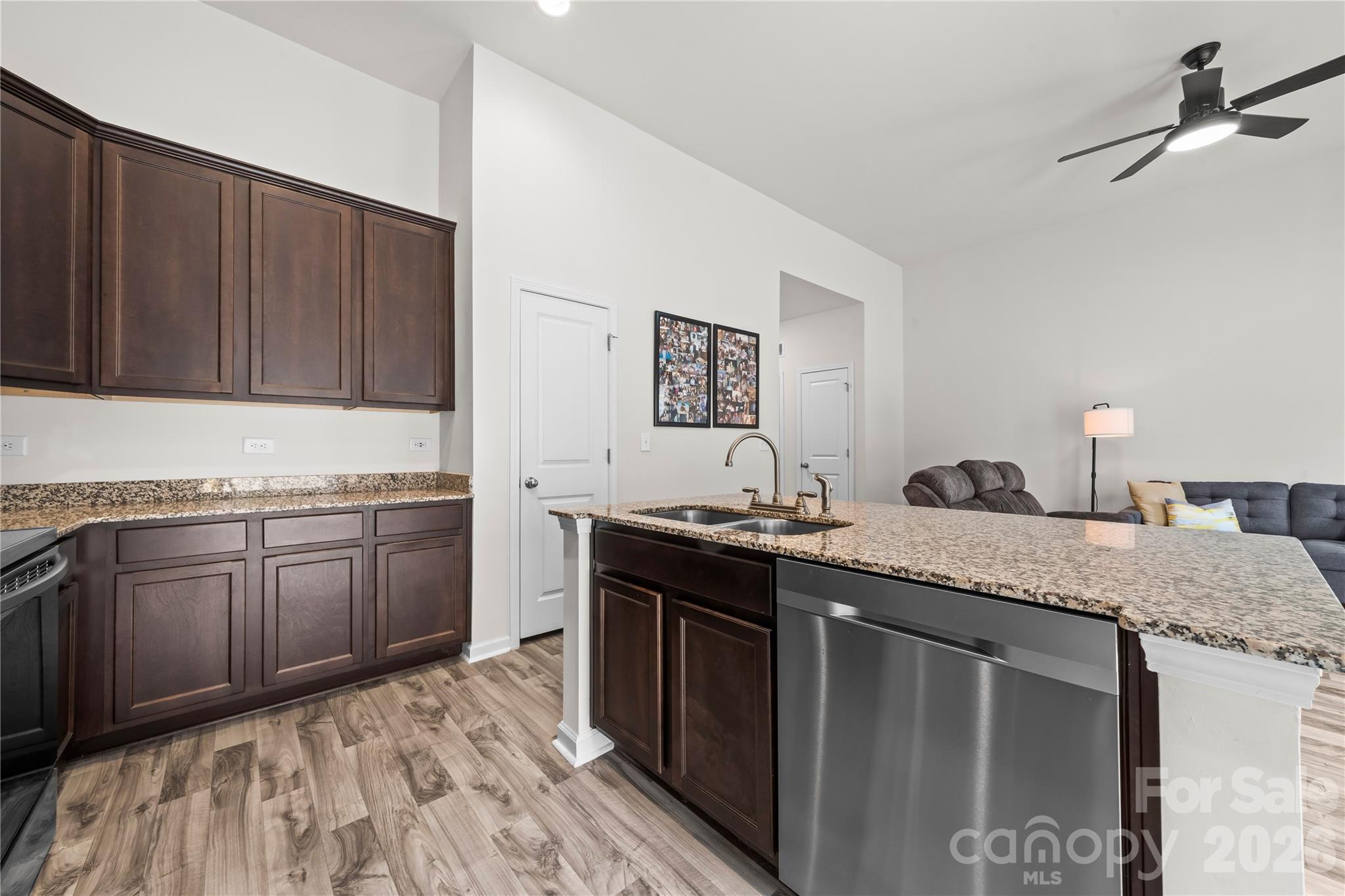 7380 Latham Way Denver, NC 28037 - Photo 6 of 39 a kitchen with stainless steel appliances granite countertop a sink stove and cabinets