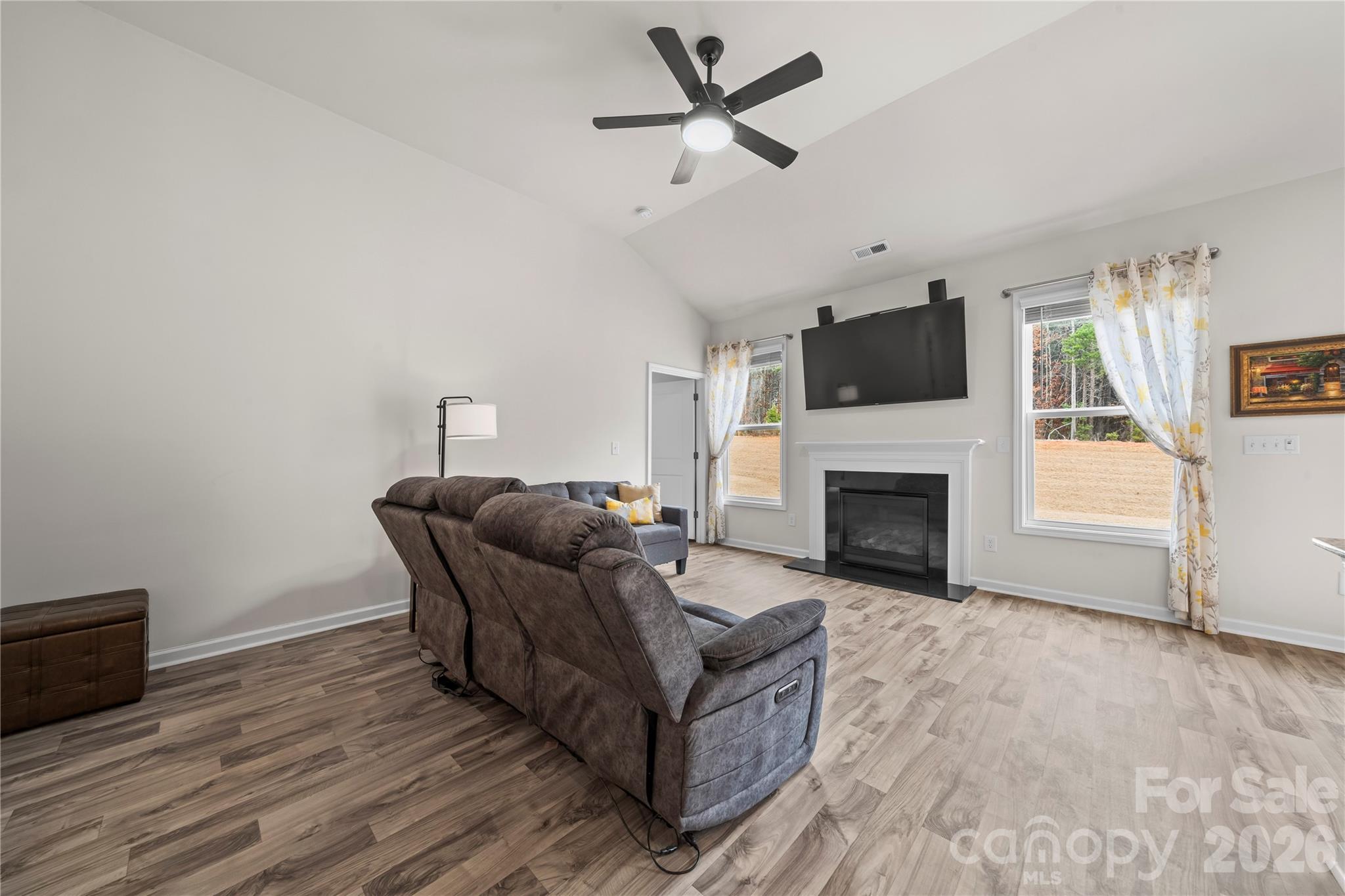 7380 Latham Way Denver, NC 28037 - Photo 10 of 39 a living room with furniture a fireplace and a flat screen tv