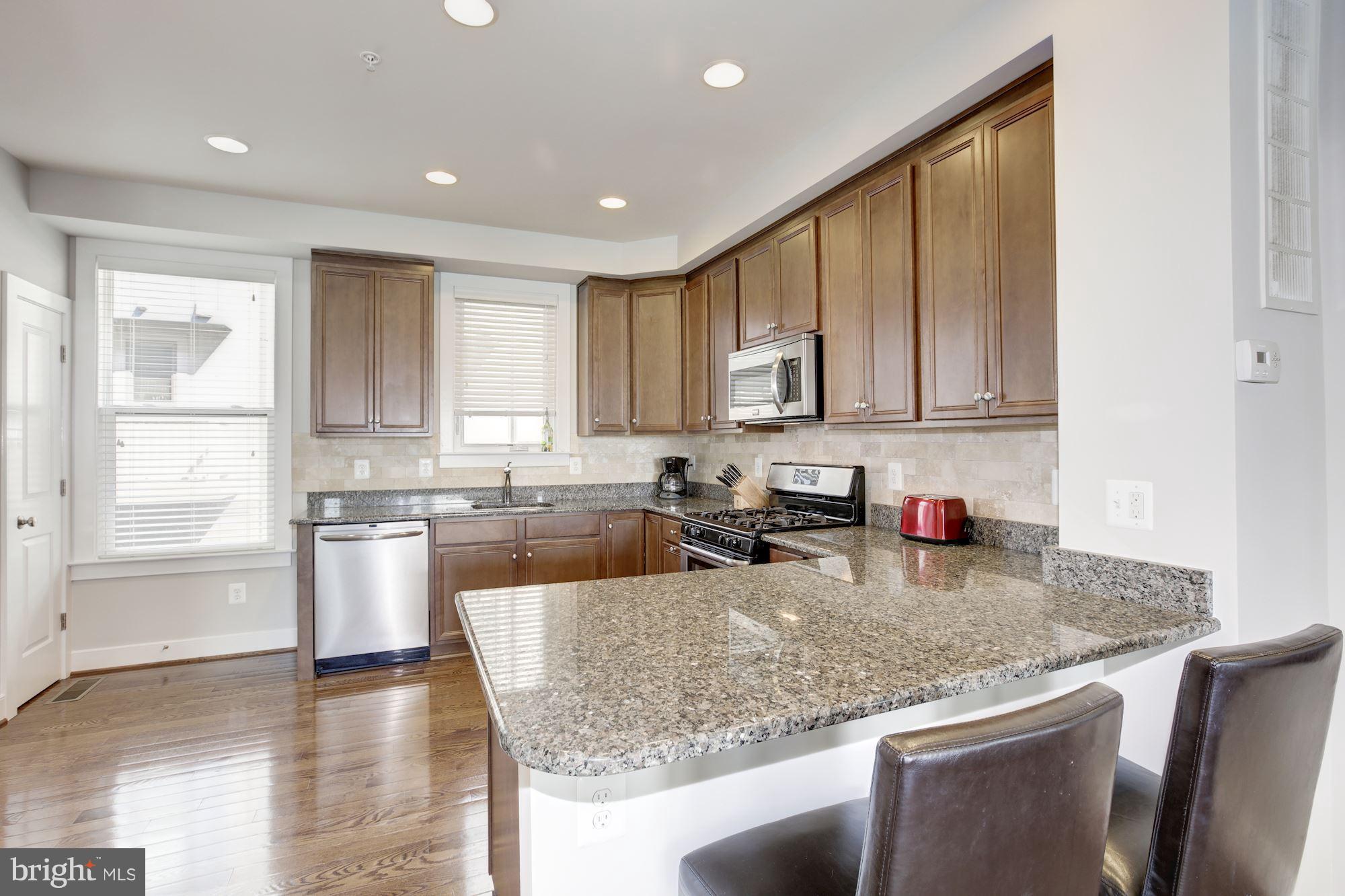 2957 Eskridge Road Fairfax, VA 22031 - Photo 2 of 30 a kitchen with stainless steel appliances granite countertop a stove a sink and a microwave