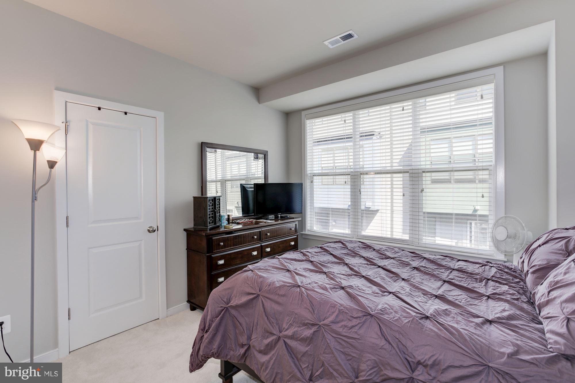 2957 Eskridge Road Fairfax, VA 22031 - Photo 12 of 30 a bedroom with a bed and a flat screen tv