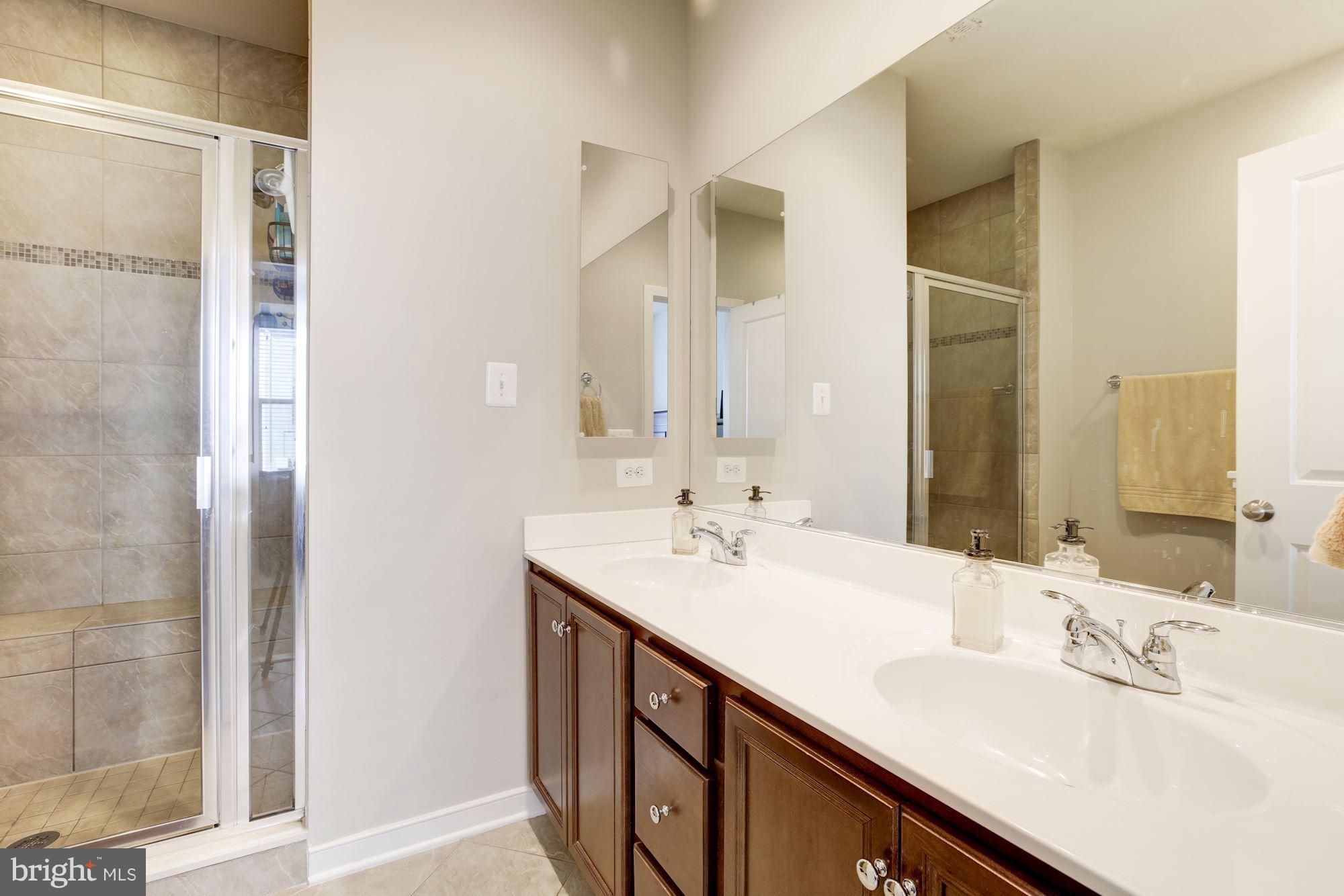 2957 Eskridge Road Fairfax, VA 22031 - Photo 13 of 30 a bathroom with a sink double vanity and a mirror