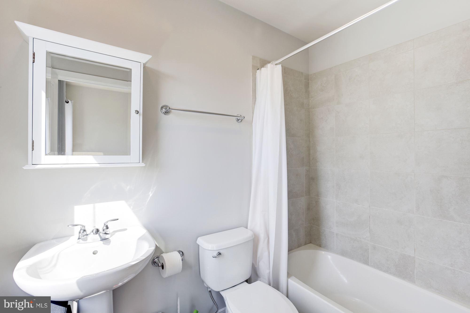 2957 Eskridge Road Fairfax, VA 22031 - Photo 16 of 30 a bathroom with a sink toilet and shower