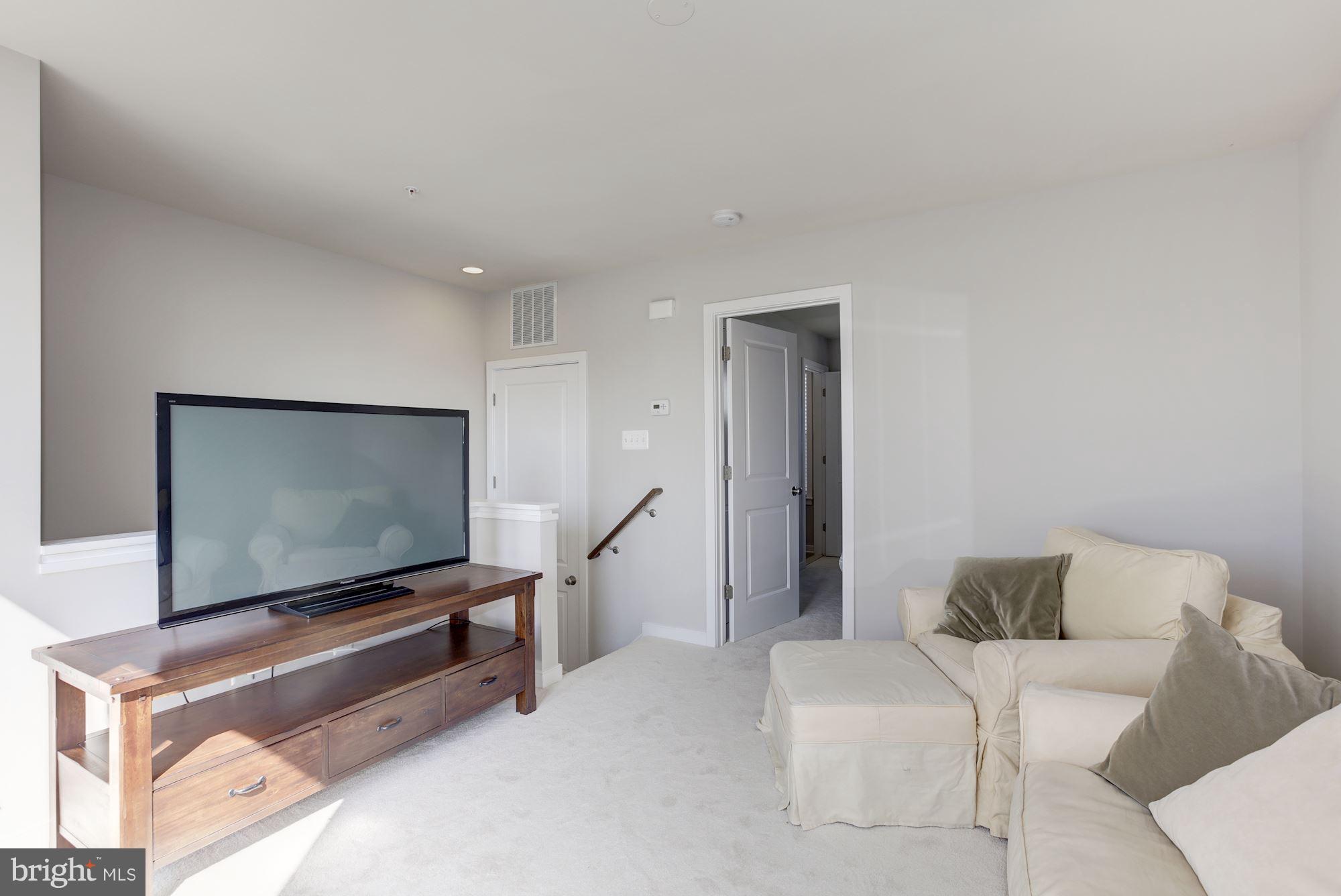 2957 Eskridge Road Fairfax, VA 22031 - Photo 19 of 30 a living room with furniture and a flat screen tv