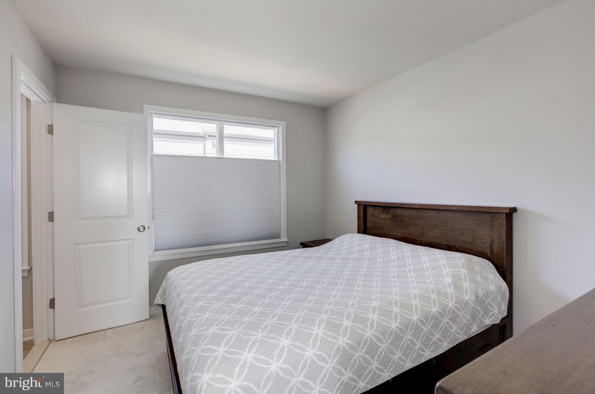 2957 Eskridge Road Fairfax, VA 22031 - Photo 20 of 30 a bedroom with a bed and window