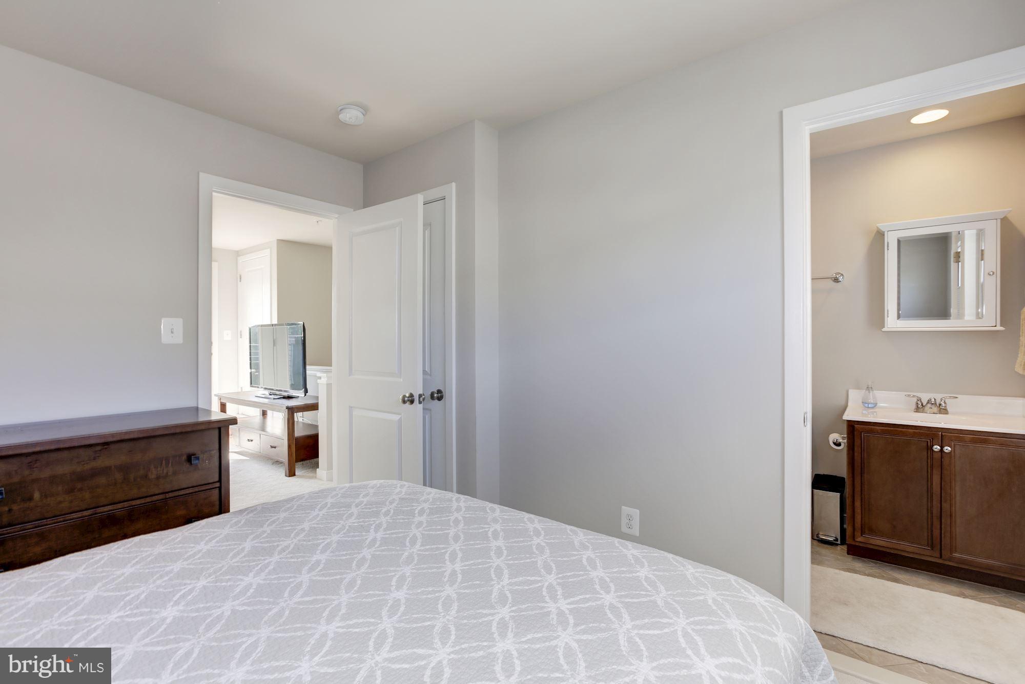 2957 Eskridge Road Fairfax, VA 22031 - Photo 21 of 30 a bedroom with a bed and a dresser