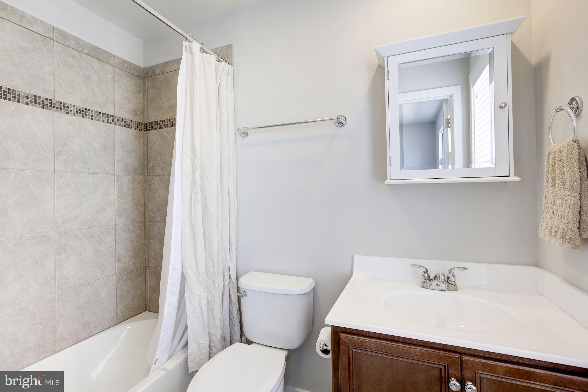 2957 Eskridge Road Fairfax, VA 22031 - Photo 22 of 30 a bathroom with a sink toilet and shower