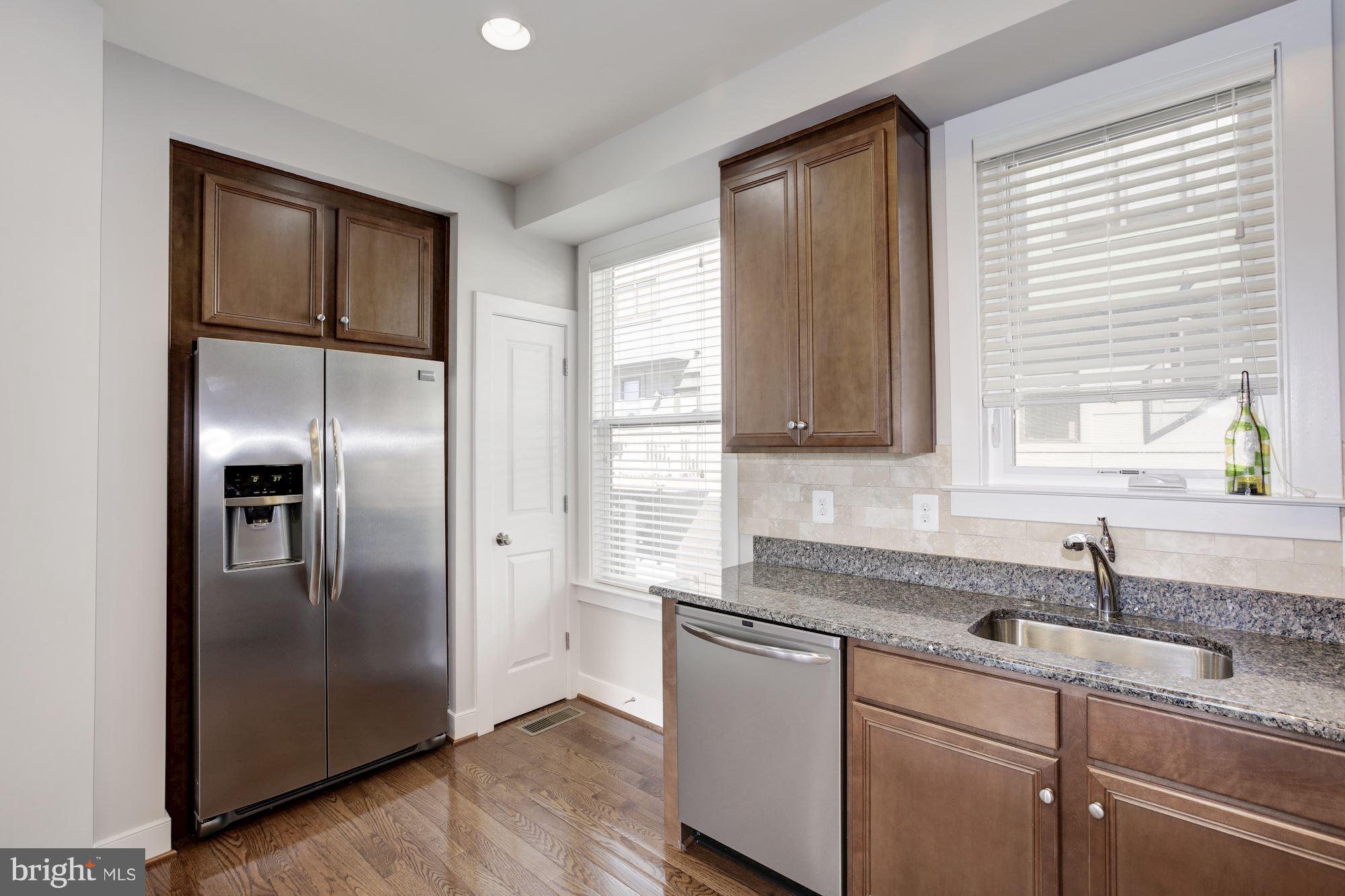 2957 Eskridge Road Fairfax, VA 22031 - Photo 4 of 30 a kitchen with stainless steel appliances granite countertop a refrigerator a sink and a granite counter tops