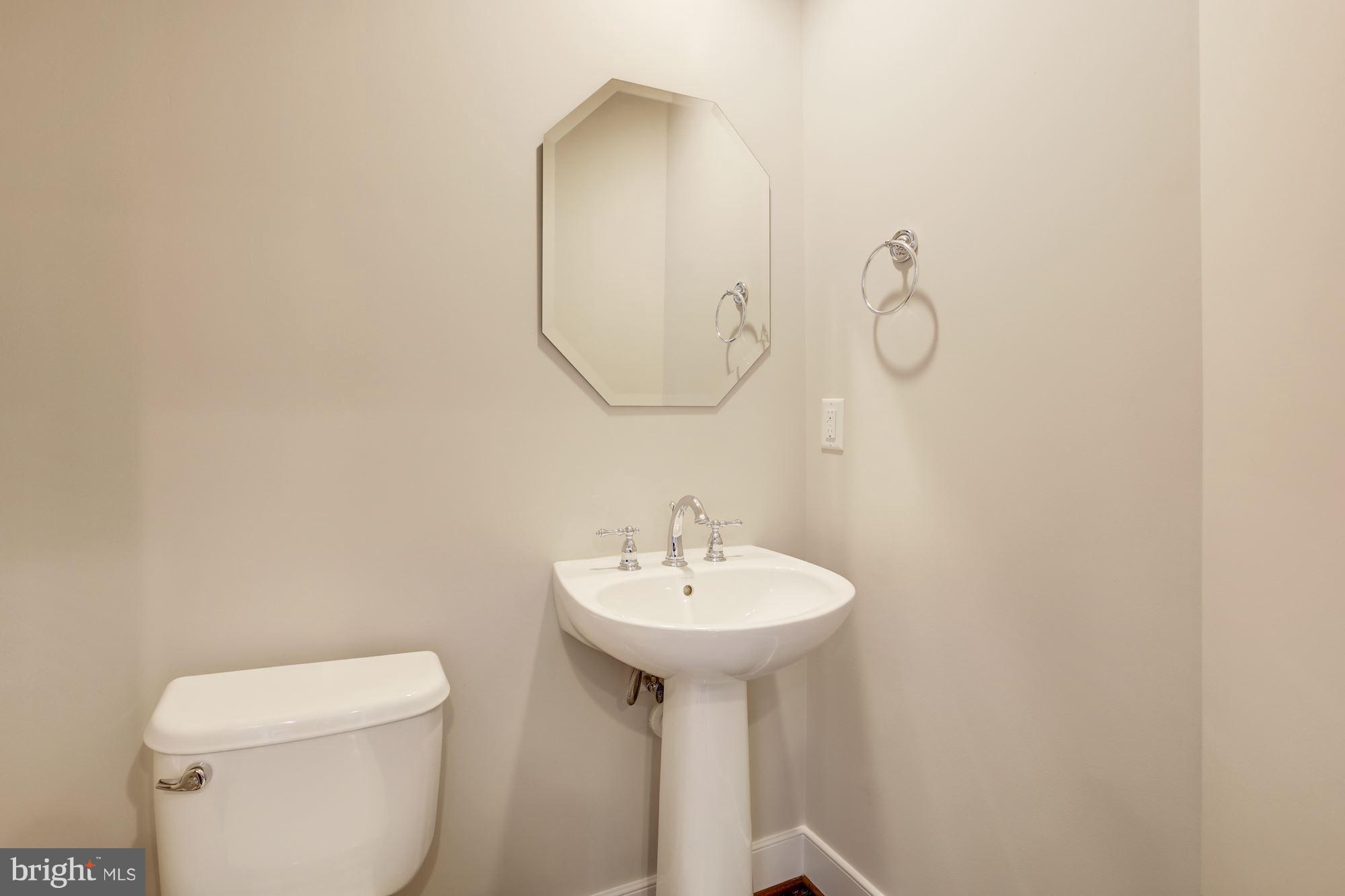 2957 Eskridge Road Fairfax, VA 22031 - Photo 10 of 30 a bathroom with a sink a mirror and toilet