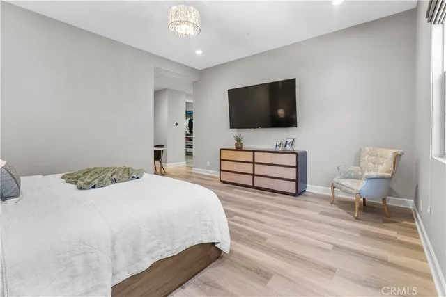 a spacious bathroom with a double vanity sink a large mirror and bathtub