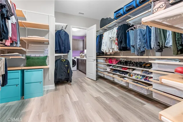 a spacious bathroom with a double vanity sink a large mirror and shower