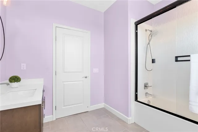 a front view of a house with a yard and potted plants
