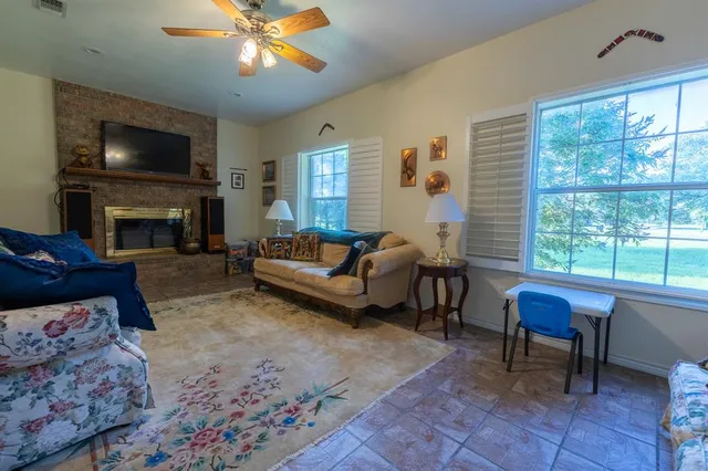 a living room with furniture a dining table and a clock