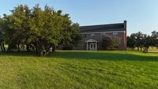 a view of a green field with trees