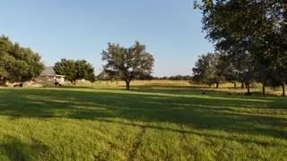 an aerial view of residential houses with outdoor space and lake view