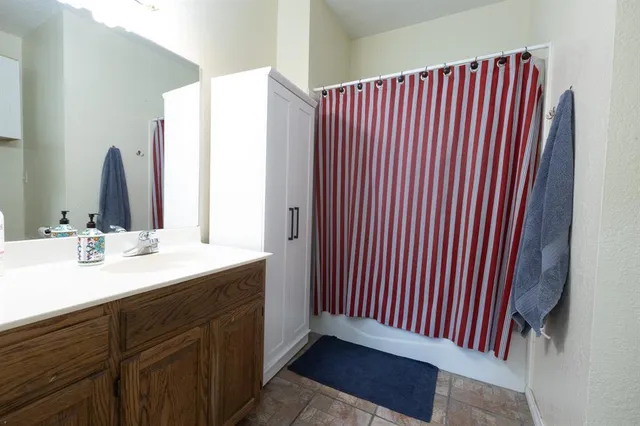 a bathroom with a sink and shower