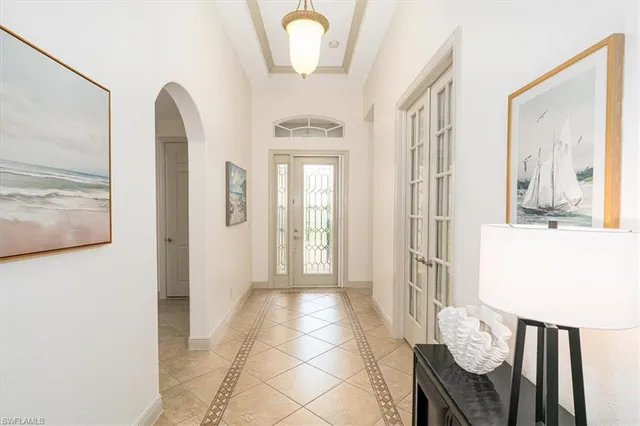 a view of a hallway with furniture and windows